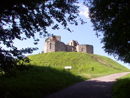 Stafford Castle, motte and bailey earthworks surmounted by remains of later castles.